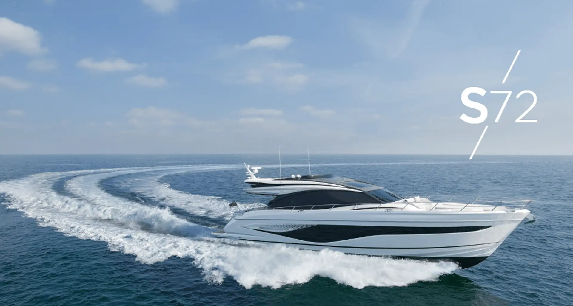 High-performance yacht Princess S72 making a swift turn on the sea, leaving a curved wake in its path.